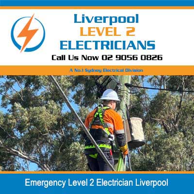Emergency level 2 electrician in safety gear working on overhead power lines in Liverpool