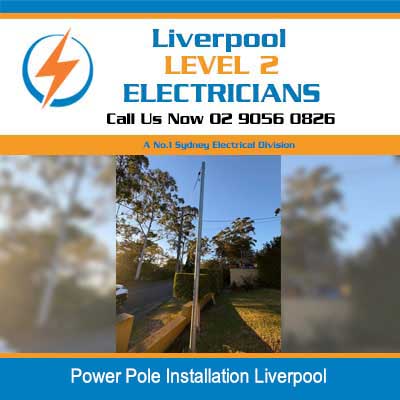 Power pole installation with overhead electrical lines along residential pathway in Liverpool